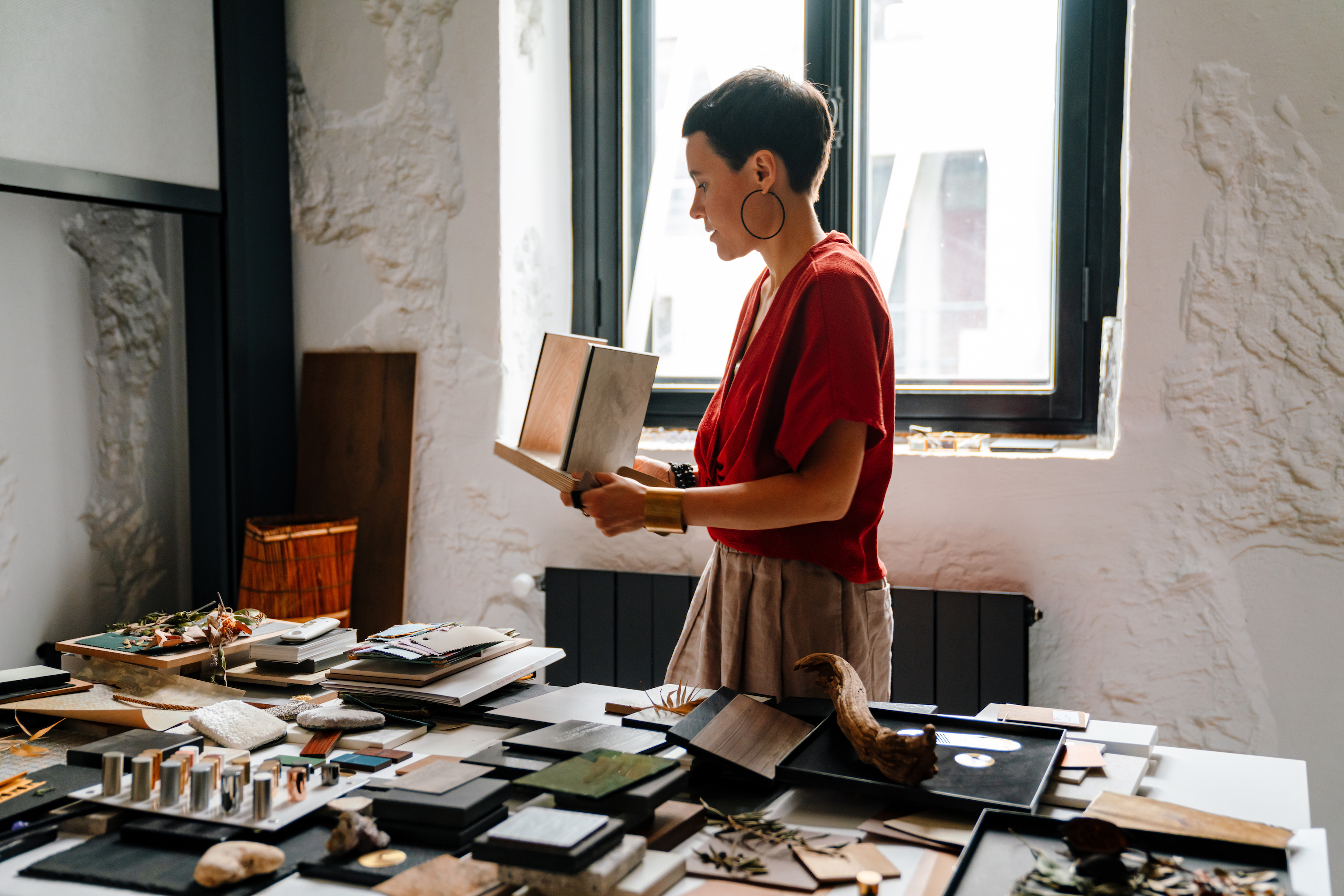 A designer in an office with wood samples