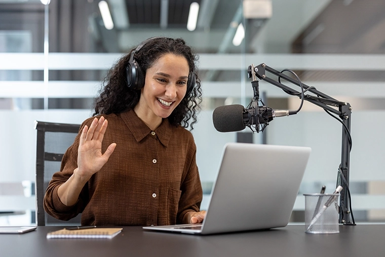 A women attending a virtual meeting using an additional microphone.