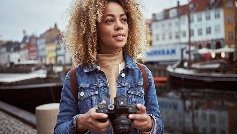 Travel photographer holding a camera