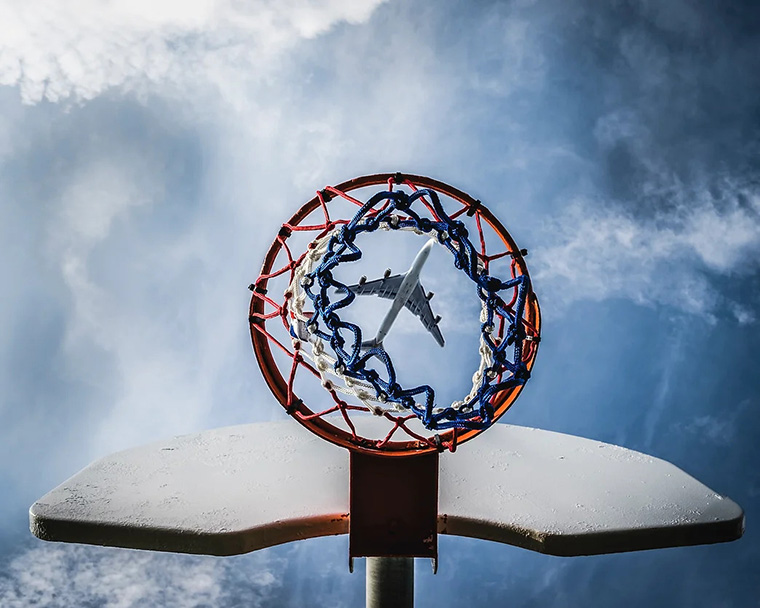 Photo of an airplane framed in a basketball net, taken by Anthony Jackson