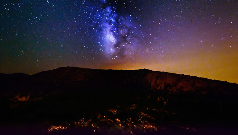 The Milky Way over a mountain at night