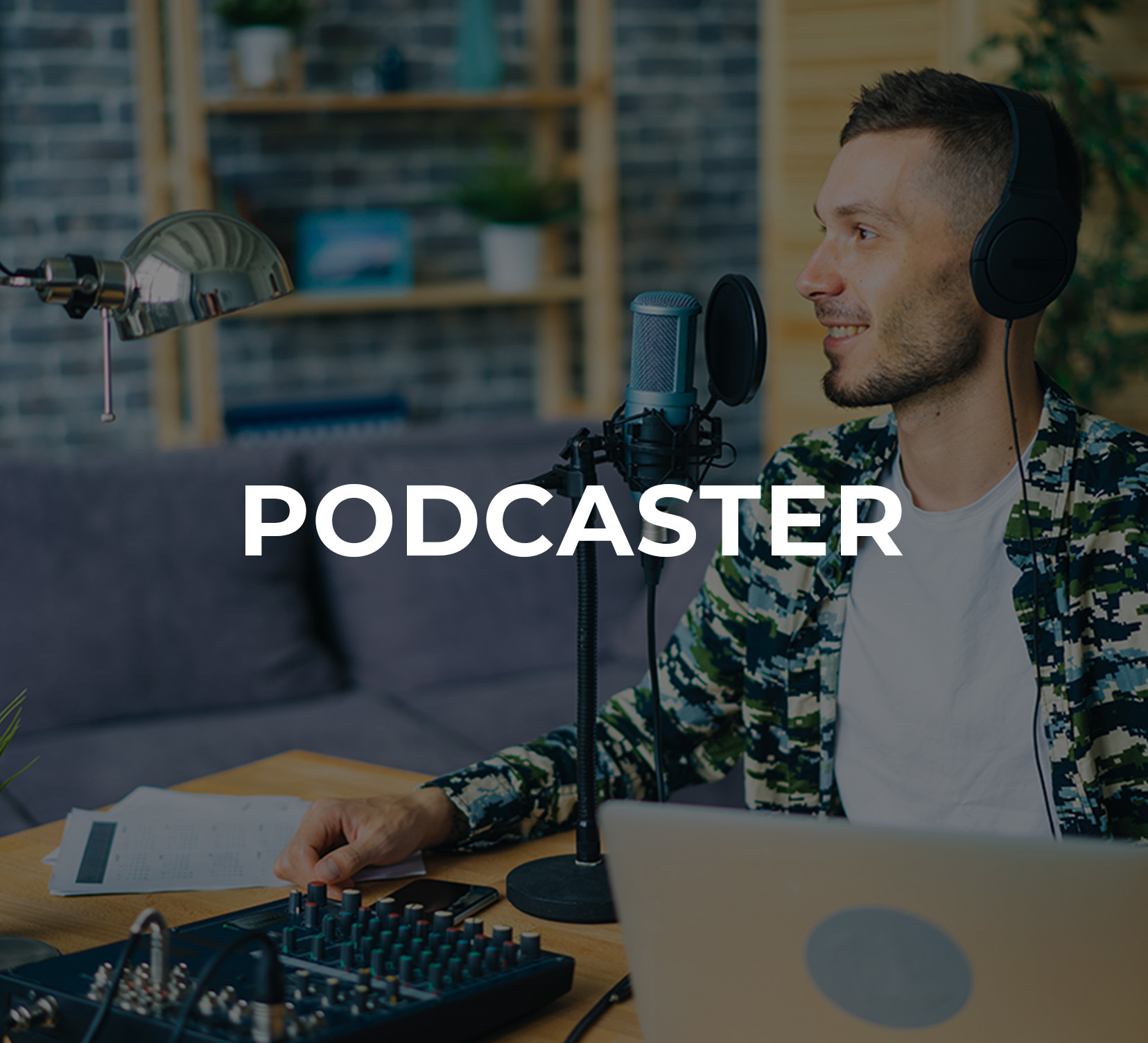 A young man sitting at a desk recording a podcast