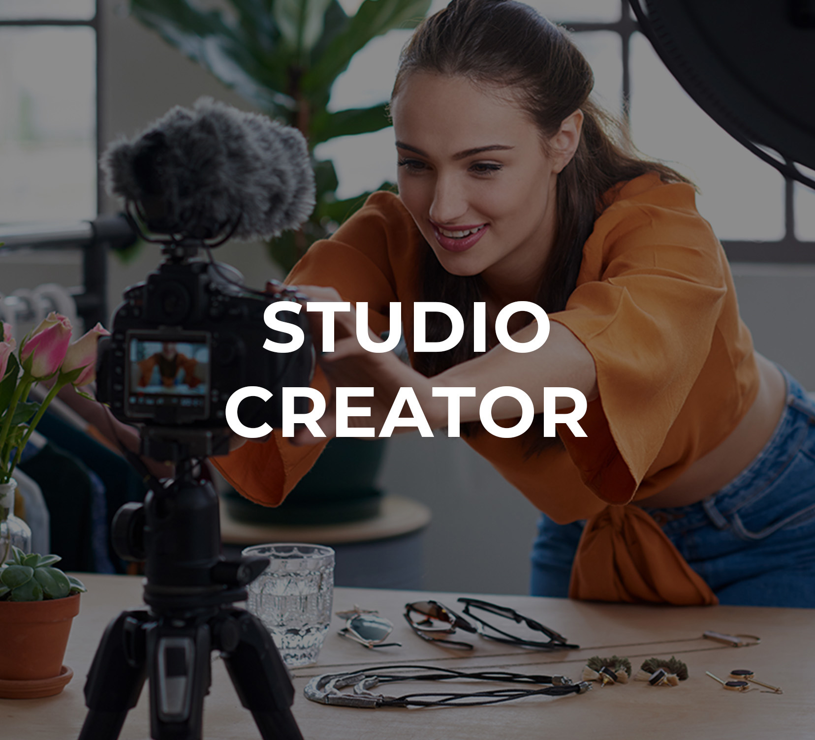 A young woman setting up a camera in her home studio