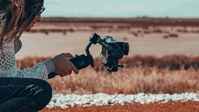 A woman kneeling down taking a photo