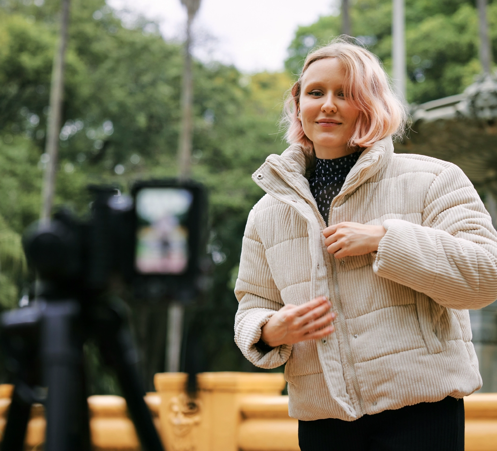 A content creator filming a youtube video outside