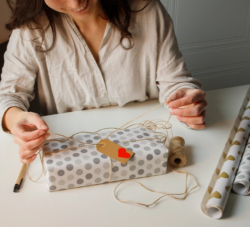 Woman wrapping a Valentine's Day gift