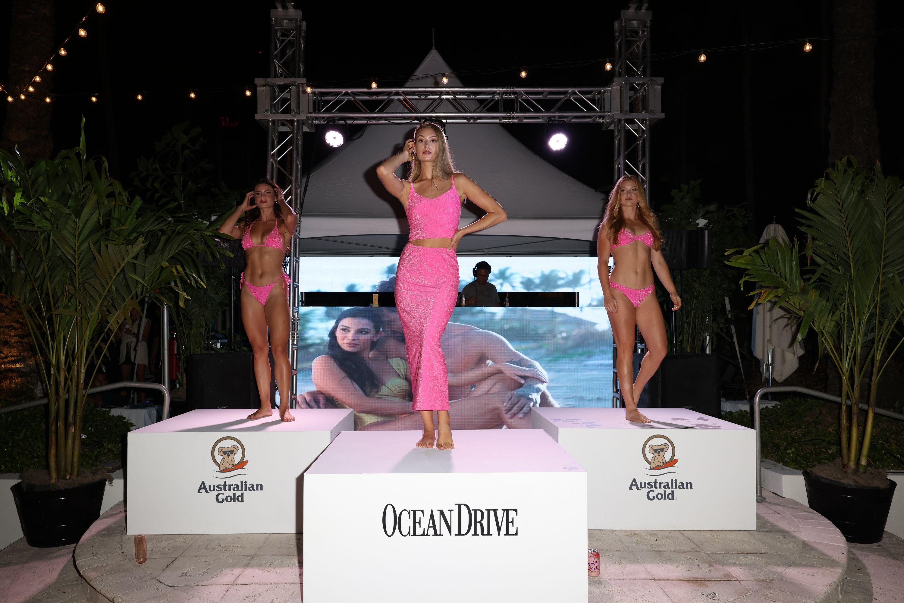 Models wearing pink on runway stage