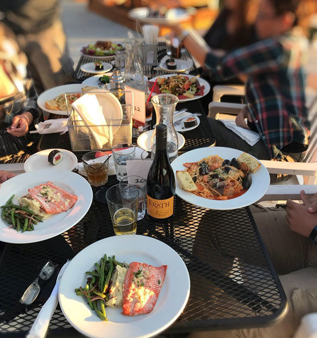 People enjoying food and Erath wine outdoors