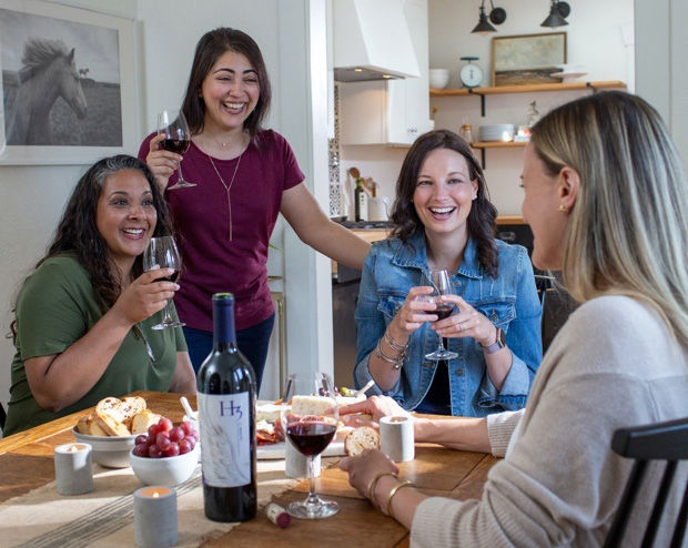 Women cheering with H3 wine