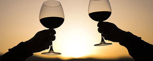 Silhouette of people clinking glasses