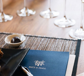 Tasting menu and wine glasses on a table