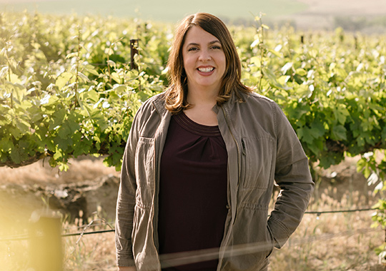 Winemaker Katie Nelson in a vineyard