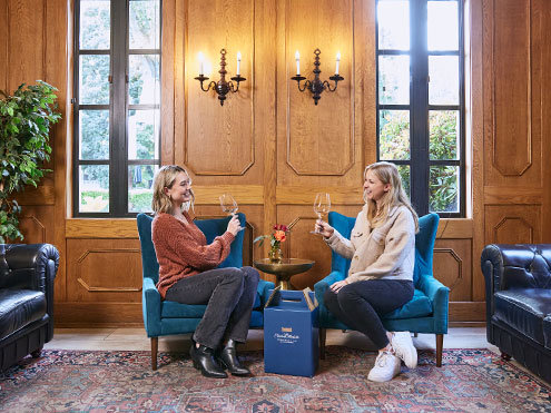 Two women enjoying wine in the club room