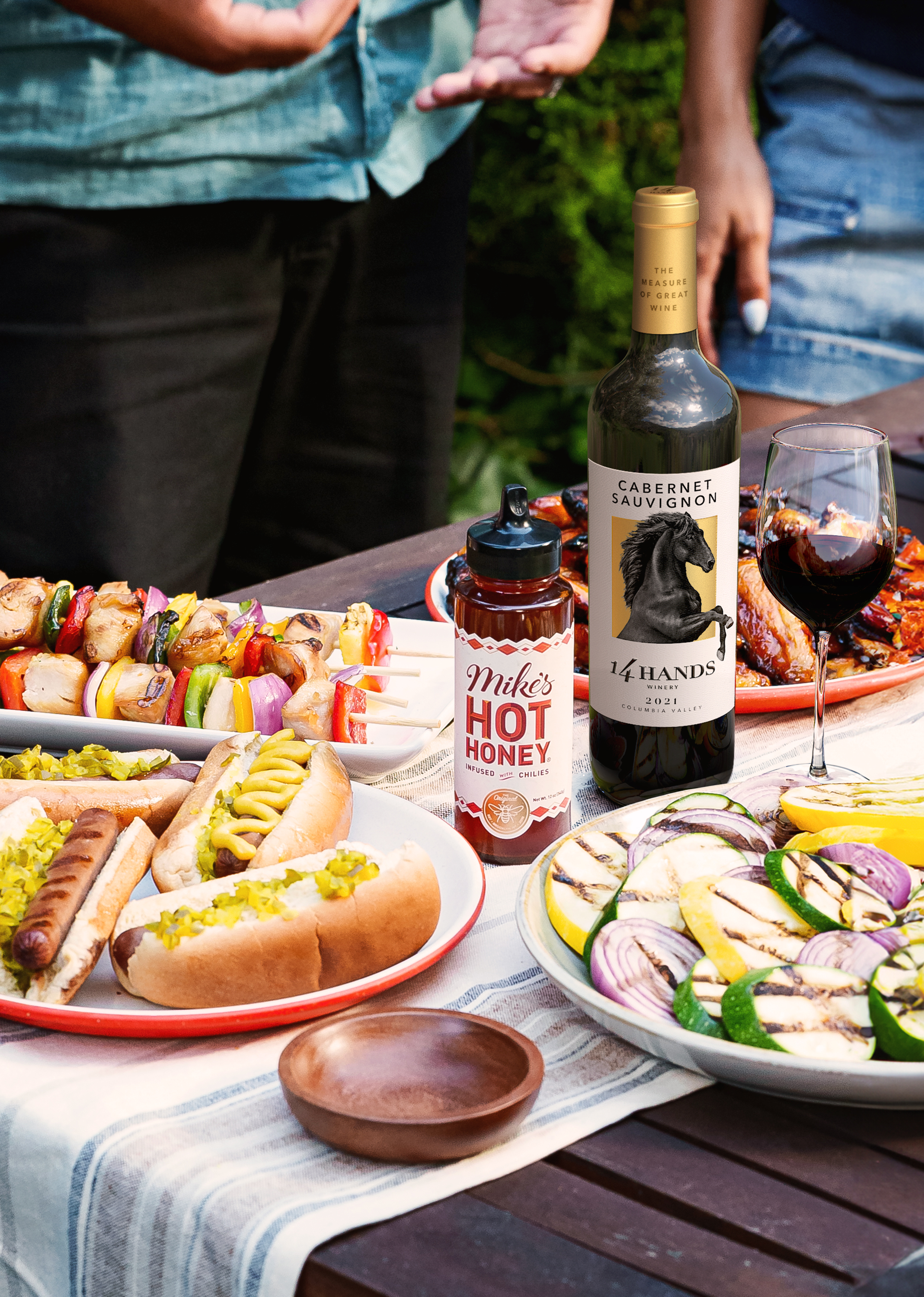 Mike's Hot Honey and 14 Hands Wine on a table