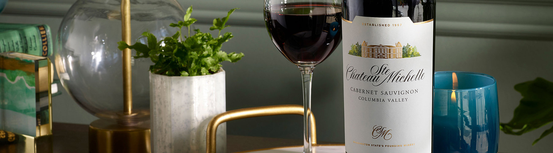 Wine bottle on a table with candle