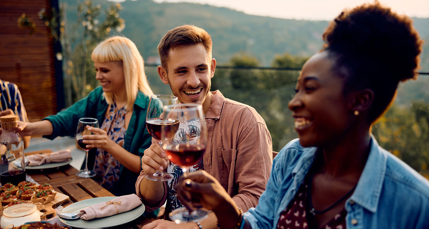 People enjoying wine at an outdoor table