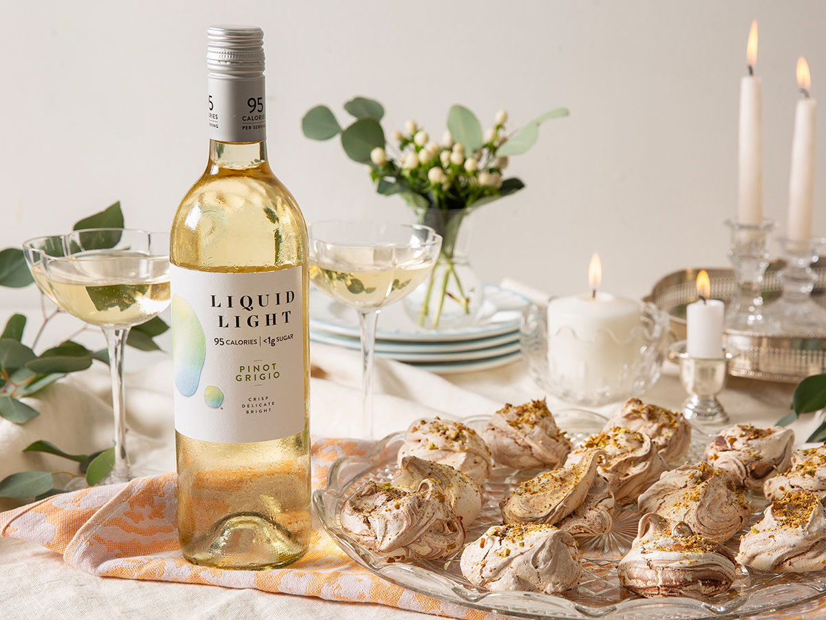 Bottle of Liquid Light Pinot Grigio and Pistachio Cookies on a table