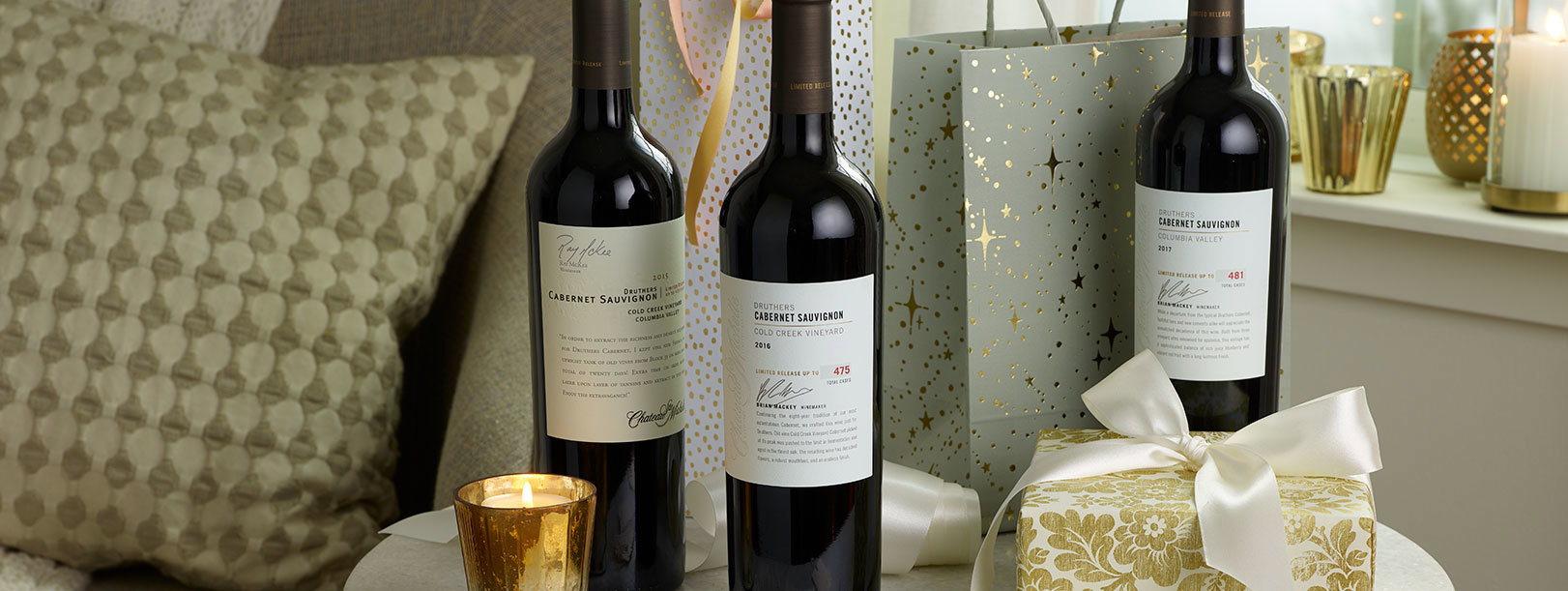 Three bottles of Druthers on a table with holiday gifts