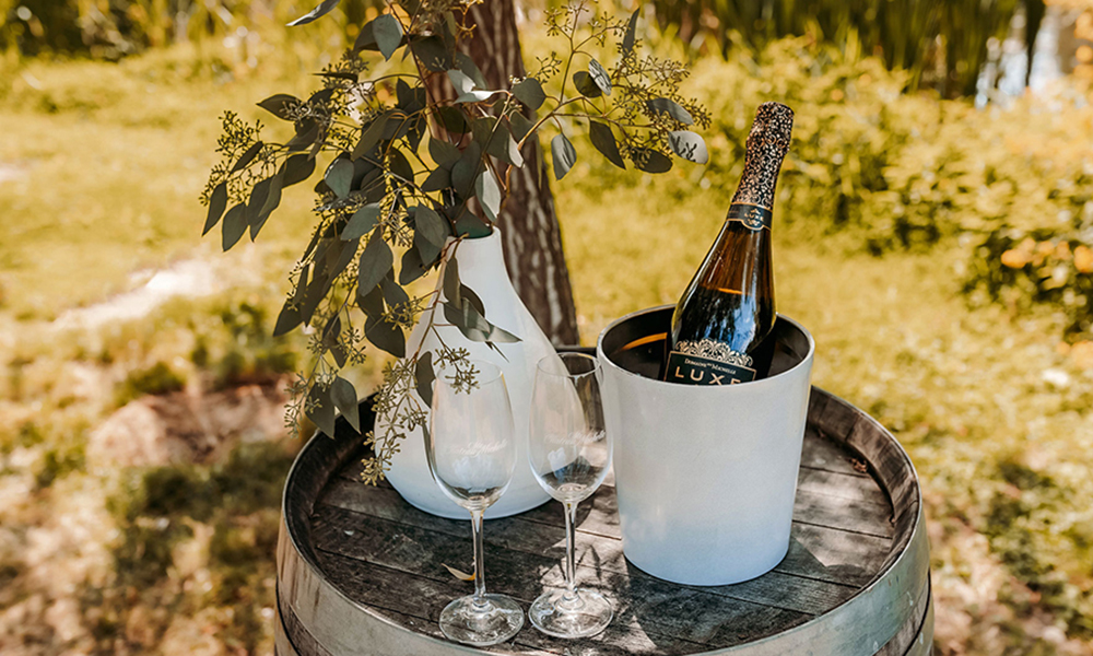 Luxe Sparkling Wine on a wine barrel