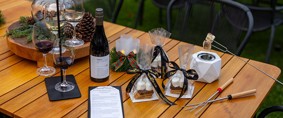 S'mores set up on a table with wine