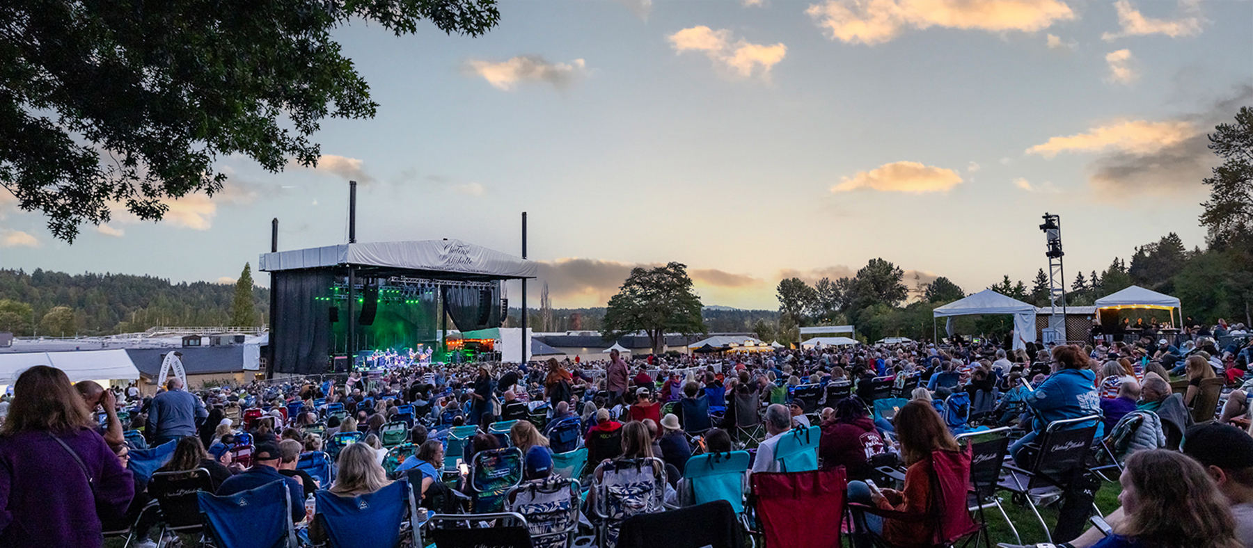  people on chairs in an amphitheater, watching a concert at Chateau Ste Michelle
