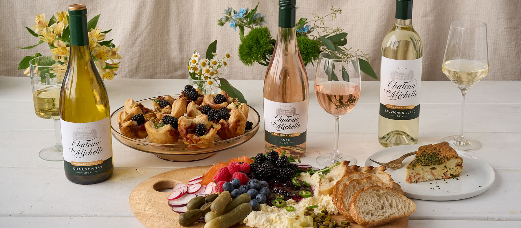 bottles of Chateau Ste. Michelle and food on a table