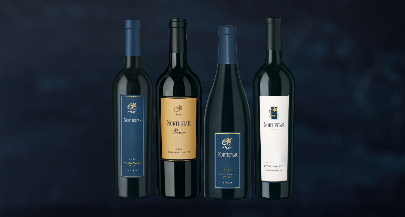 Woman holding up a glass of wine and smiling