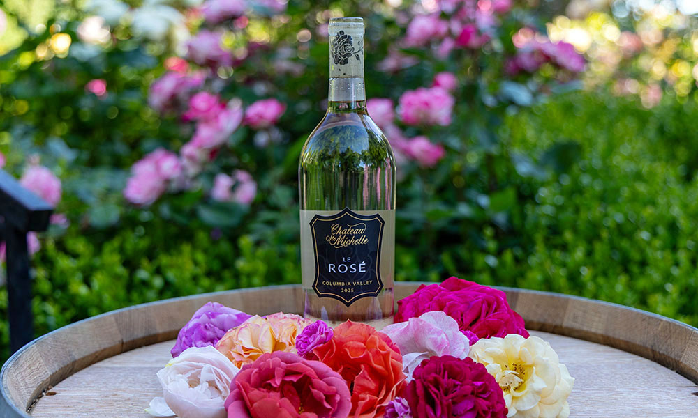 Bottle of Le Rose with roses