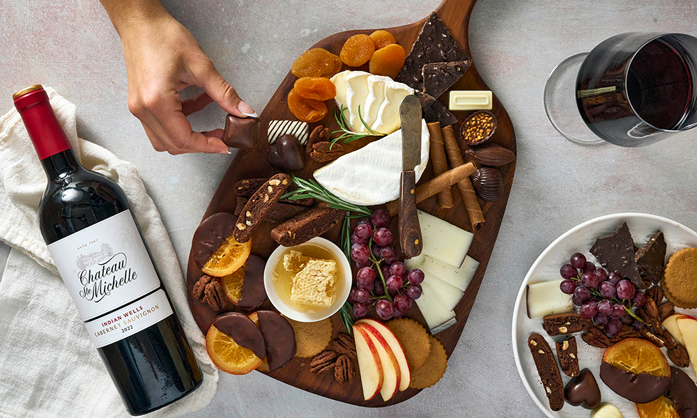 charcuterie board on a table with a bottle of wine