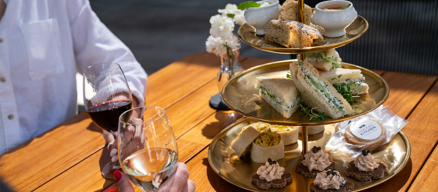 people cheering with wine glasses next to a food dish