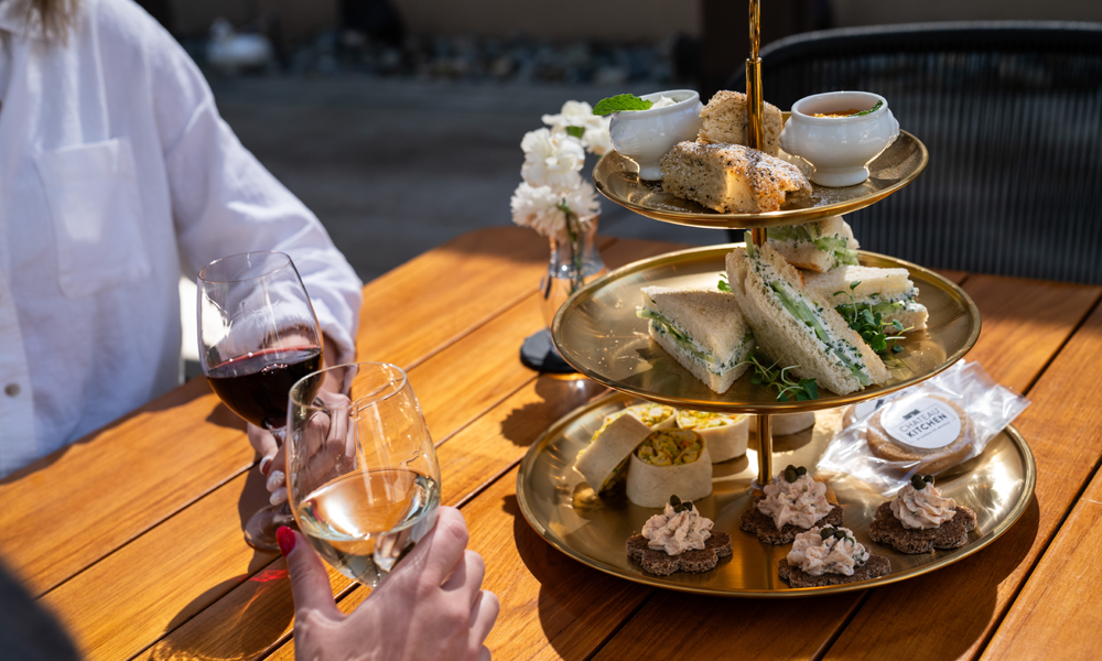 people cheering with wine glasses next to a food dish