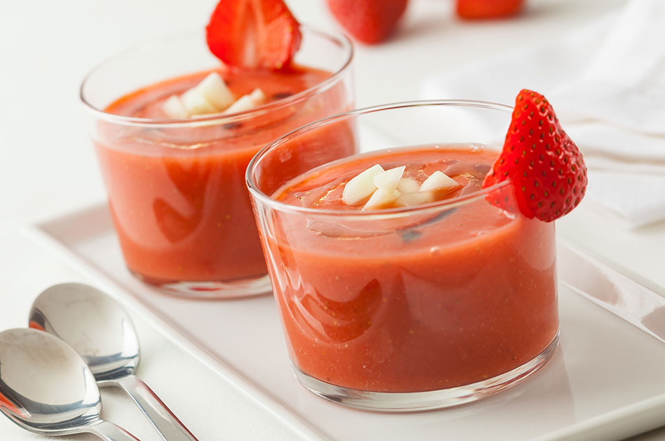 Small glasses filled with strawberry gazpacho