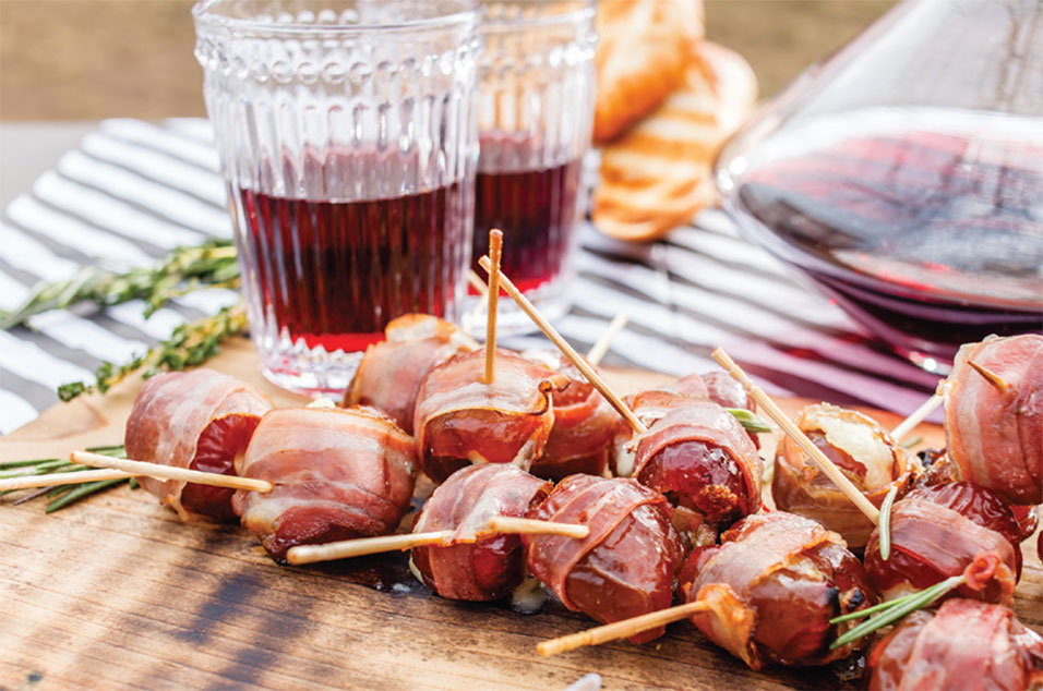 Chorizo stuffed dates on a table