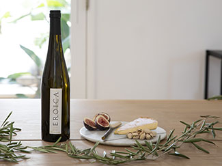 bottle of Eroica XLC on a table with appetizers