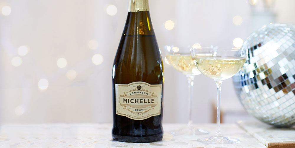 Bottle of Brut with glasses and a disco ball