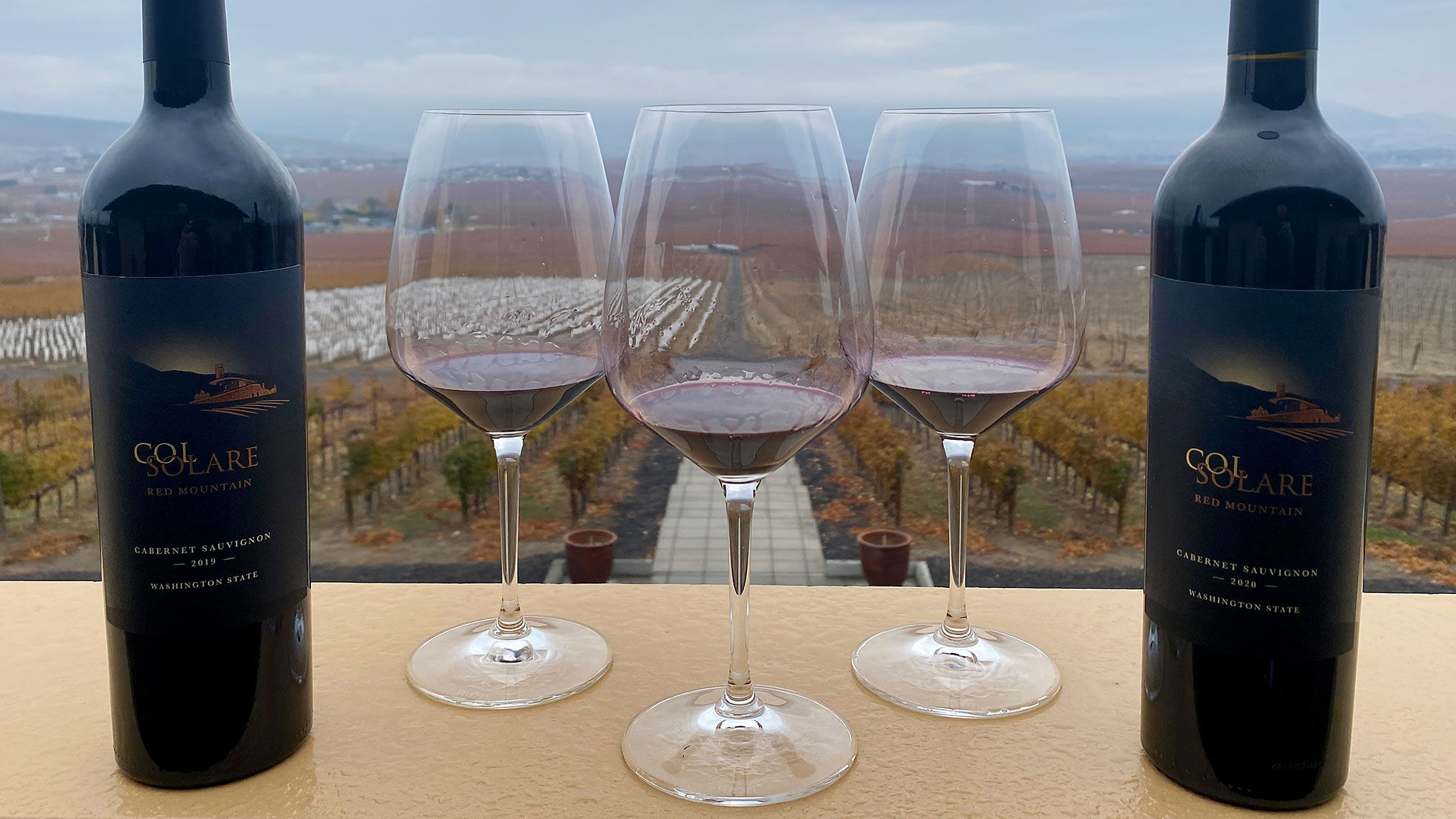 Glasses of wine with bottles of Col Solare