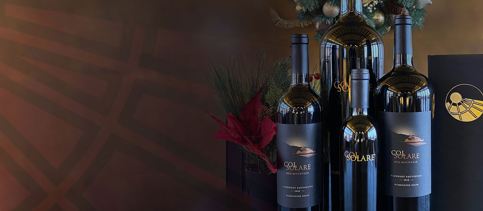 Bottles of Col Solare wine in front of a holiday wreath