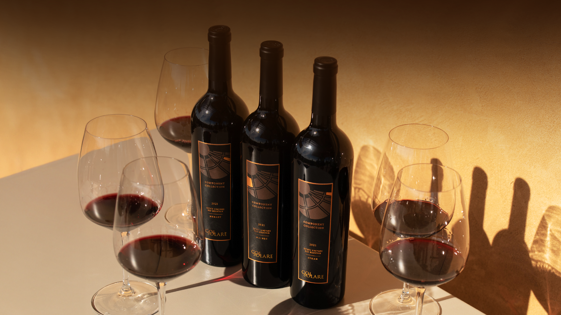 Bottles of Col Solare wine with glasses of red wine