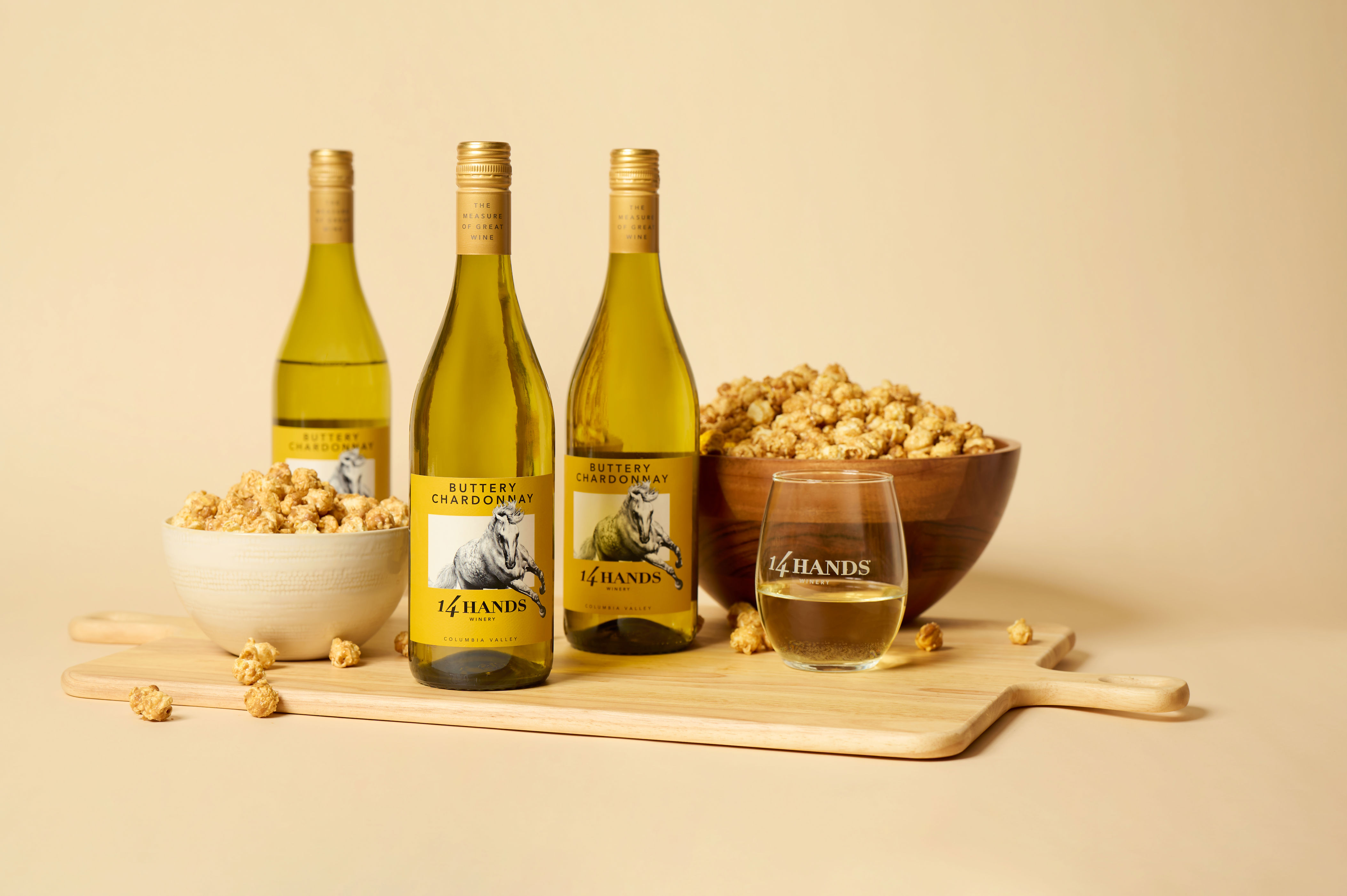 Bottles of 14 Hands Buttery Chardonnay and popcorn