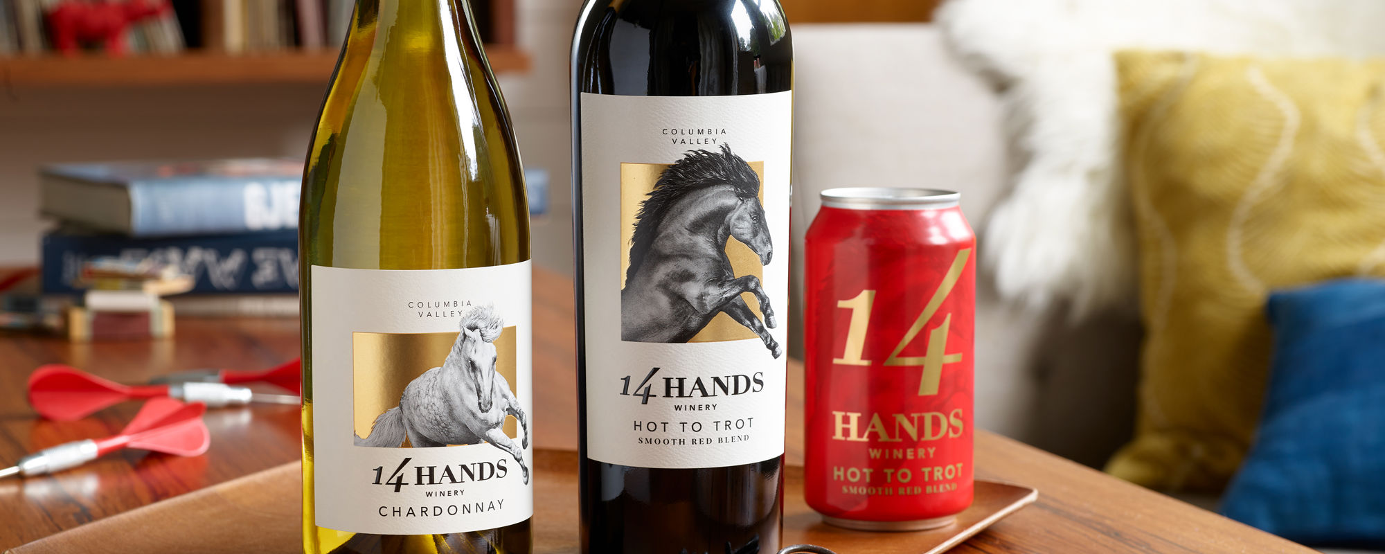 14 Hands essentials wine bottles and can on a table
