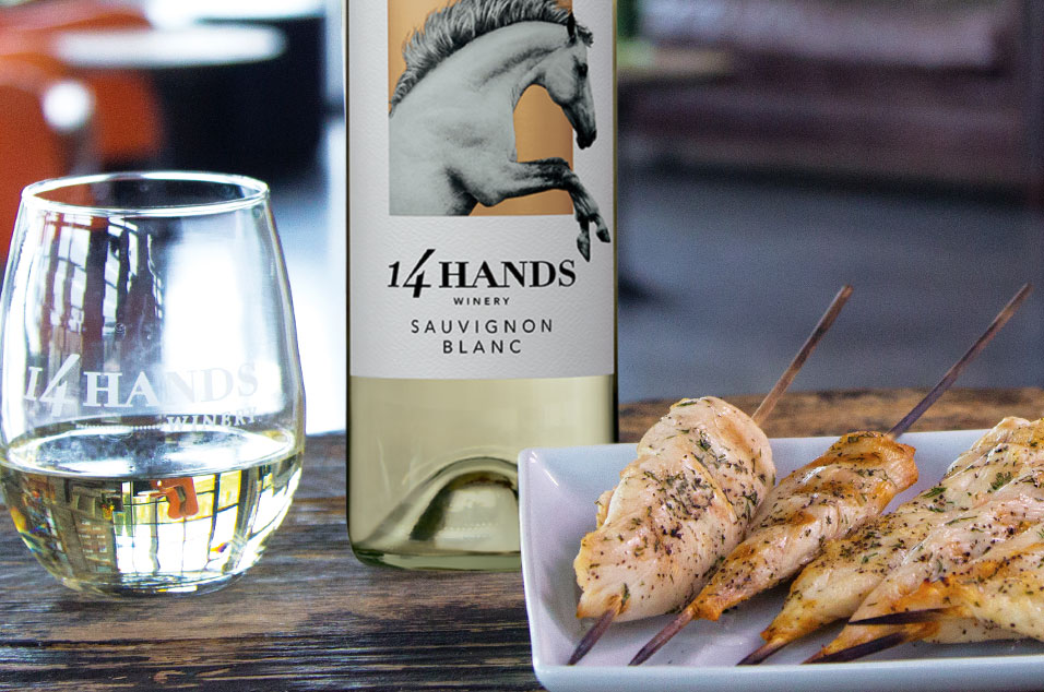 Chicken skewers on a plate with wine