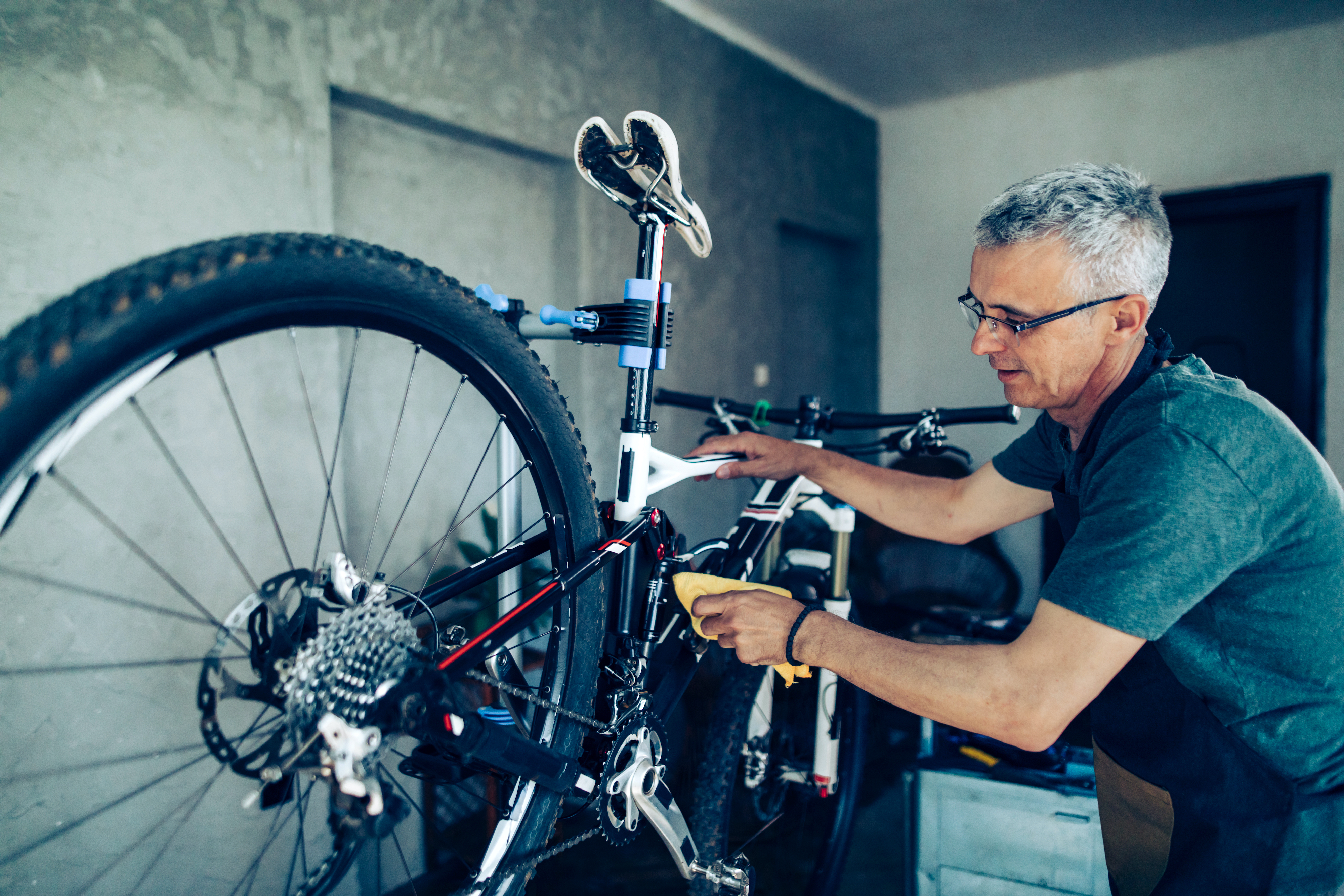 Man works on a racing mountain bike before race