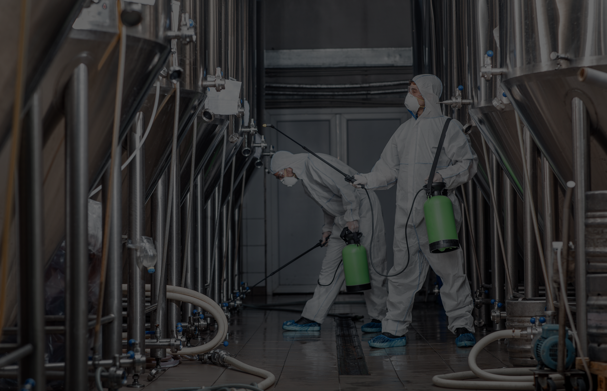 People cleaning brewery with chemicals