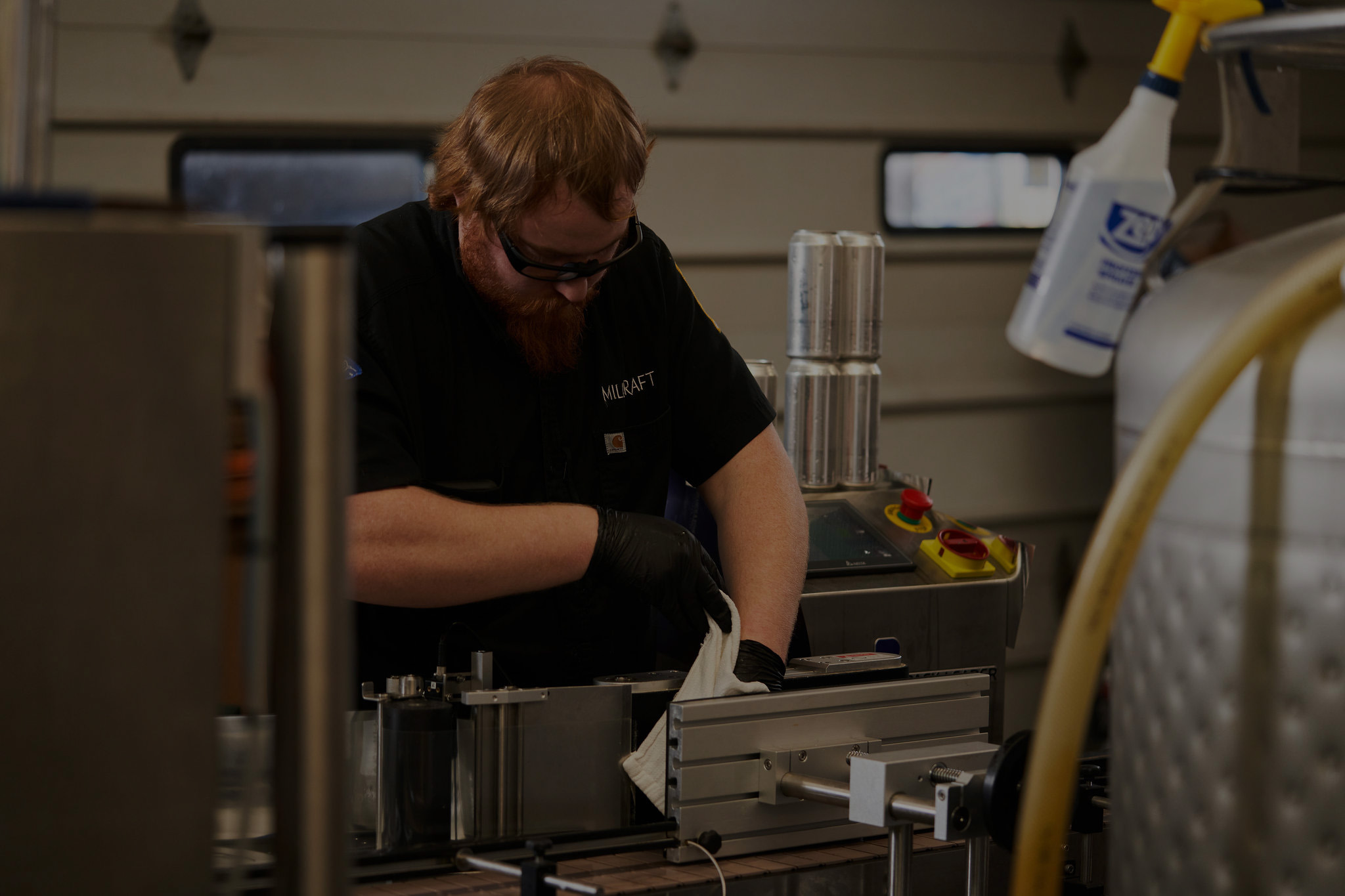 Employee cleaning brewery
