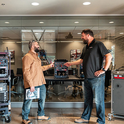 Friendly employee showing customer welding equipment in Ontario Rental Centre