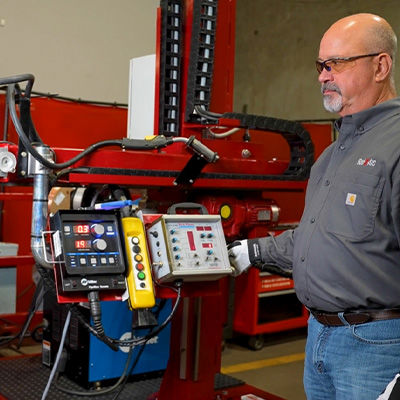 Employee operating weld automation equipment