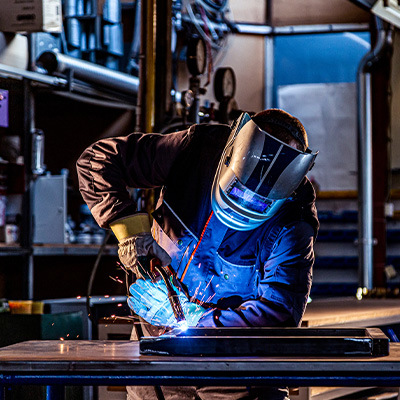 Welder MIG welding in shop