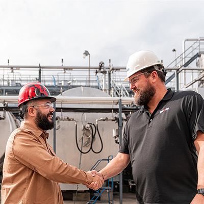 Customer and Red-D-Arc employee shaking hands in agreement on jobsite