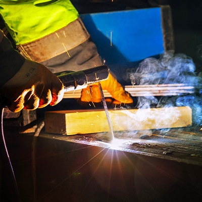 Up close shot of welder stick welding material