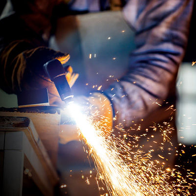 Up close shot of plasma cutter cutting through steel